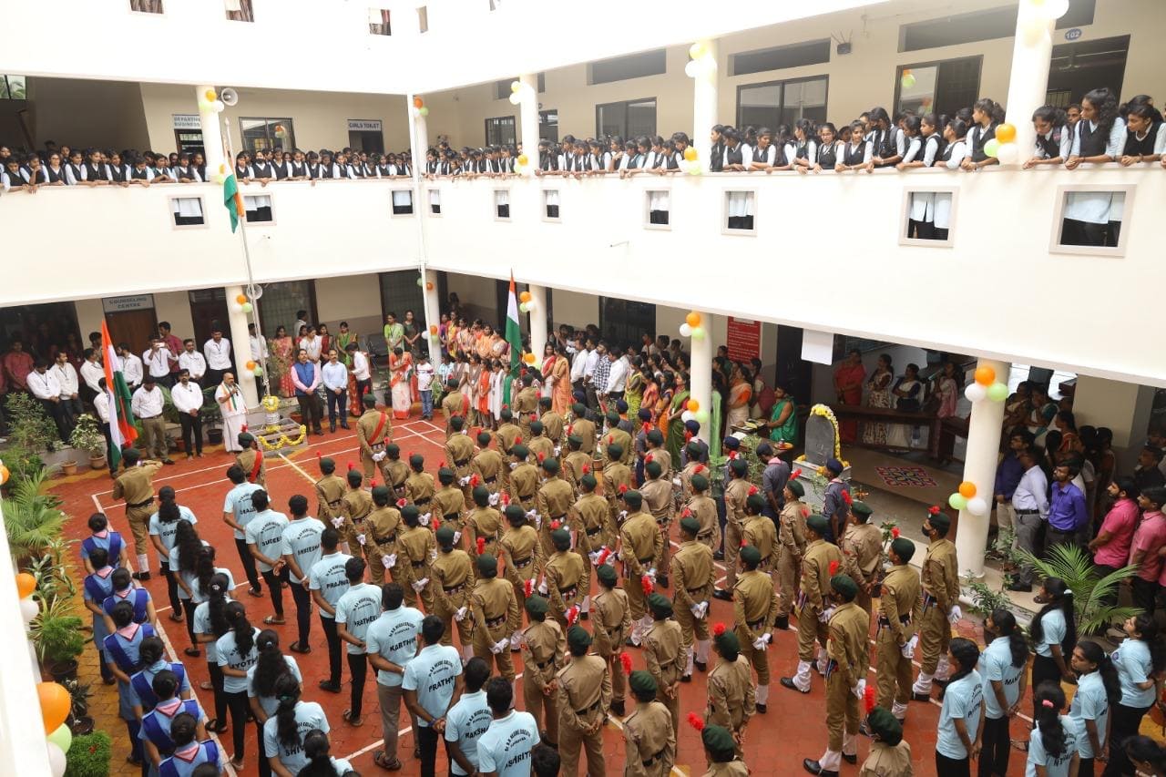 Students and staff assembled in the central college courtyard
