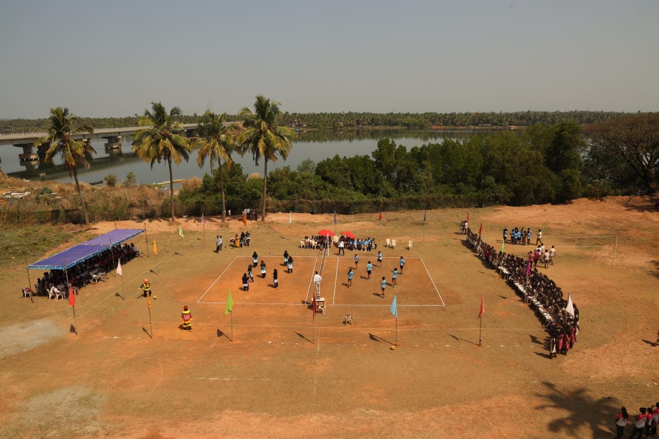 Students playing volleyball on the college sports ground